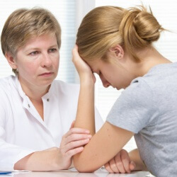 lady comforting another lady in distress